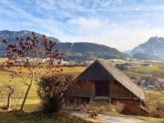 Rural house with a hayloft against a mountain landscape in Castelrotto.