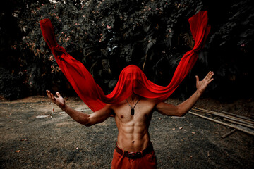 man with six packs and red veil on face falling 