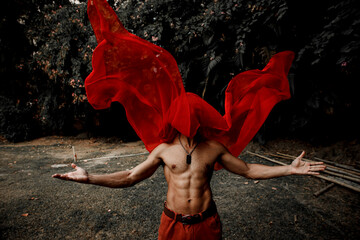 man with six packs and red veil on face falling 