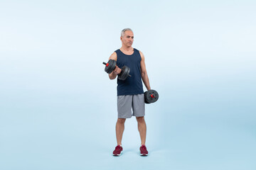 Fototapeta na wymiar Full body length shot active and sporty senior man lifting dumbbell during weight training workout on isolated background. Healthy active physique and body care lifestyle for pensioner. Clout