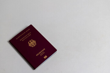 German passport on the white table, gray background, naturalization, Naturalization in Germany, Immigration and Nationality Act, 