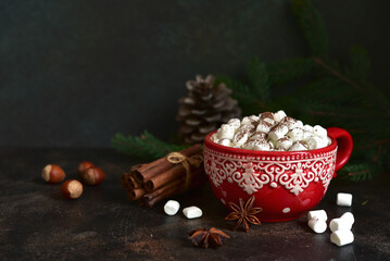 Christmas hot chocolate with marshmallow in a red cup.