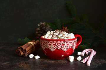 Christmas hot chocolate with marshmallow in a red cup.