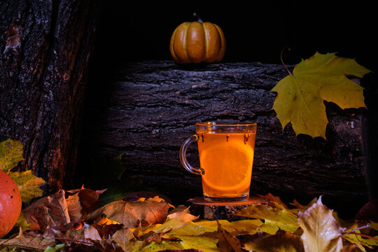 halloween style mulled beer with spices in front of wood