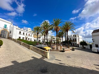 beautiful Plaza de España with fountain and palms in the historic old town of Vejer de la...