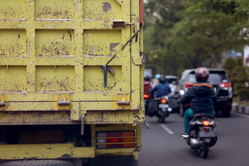 view of Indonesian traffic.  trucks and motorbikes on the highway, selective focus 