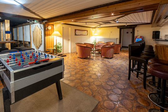 Cozy basement bar room with games and seating