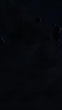 Asteroid belt field in dark outer space. 3D animation wide pan shot. Rock formations of cosmic debris and giant Meteorites. Celestial objects on starry stars background with dust nebula haze low light