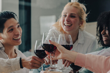 Toast between friends with glasses of red wine