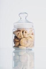 Close up of glass jars containing dried figs. Organic Sun-dried Figs. Organic farm products, healthy eating. ry fig fruit isolated on white background.