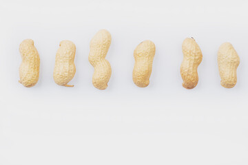 Peanuts on a white background. Groundnuts shelled and in nutshell. Dried peanuts in closeup. set of peanuts in a nutshell, unpeeled and shelled peanuts.