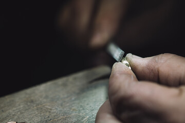macro shot of hands of Craft jeweler. Gold ring repairing. A handmade jeweler process, manufacture of jewellery. - obrazy, fototapety, plakaty