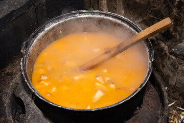 food cooking in stew pot in the nature ,romanian , tocana,traditional ceaun