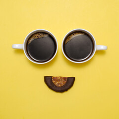 Coffee creative happy emoji. Smile from two cups of black espresso and healthy raw dessert as...