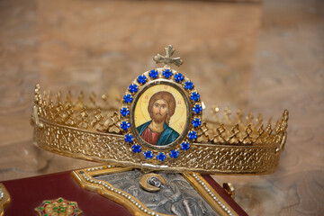The golden crown with a cross that is placed on the bride and groom's head in the Orthodox church, Romania 2023