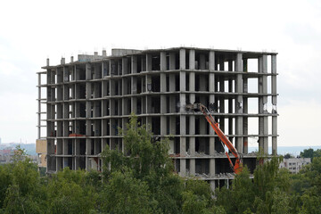 Building house destruction, demolition site excavator with hydraulic crusher machine ruin house
