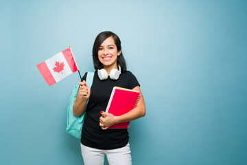 Beautiful woman holding the Canada flag learning English