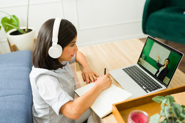 Young woman watching a streaming lesson learning english online