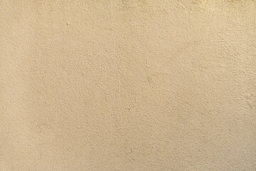 Cream yellow painted cement wall texture.