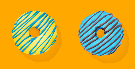 yellow and blue donut with glaze on blue and orange pastel background