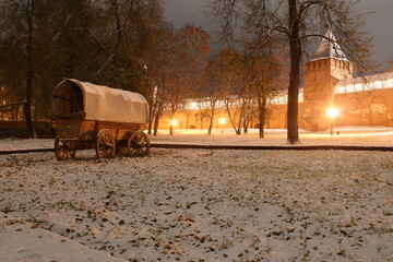 Old wooden horse carriage and old castle in winter night