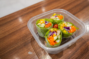 Fresh spring rolls with shrimp in rice paper. Rice paper rolls with shrimp, rice noodles, mango, lettuce and sauce.