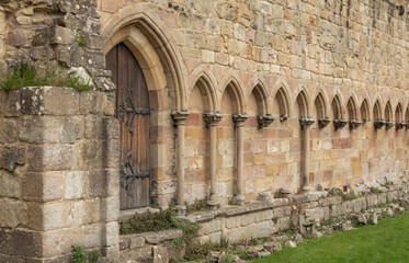 Ancient doorway and arches in the side of an abbey