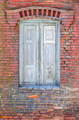Detail of a brick wall with closed window