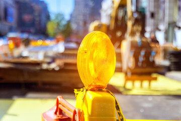 Close up of yellow warning orange construction light on barricade intended to warn construction...