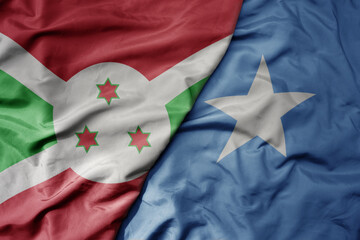 big waving national colorful flag of somalia and national flag of burundi .