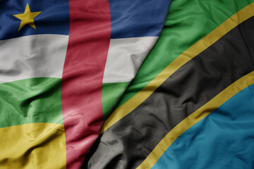 big waving national colorful flag of tanzania and national flag of central african republic .