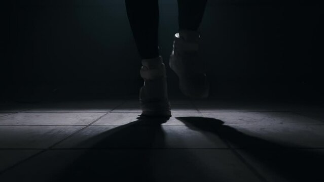 Close-up of jumping rope in a dark room with smoke with back light from the front, slow motion, 4k 