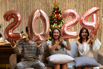 group of 3 friends holding the letters 2 0 2 4 to symbolize the new year 2024