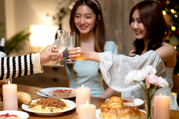 group of friends raise a glass of champagne celebrated in a fun party