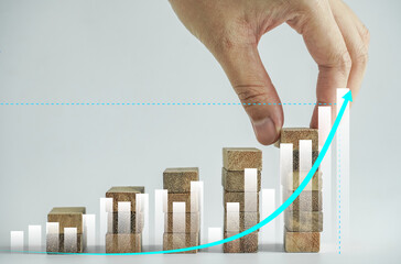 Economic growth graph and analysis of business strategies with People arranging wooden blocks into...