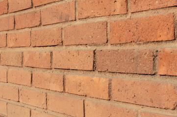 Orange color brick wall closeup perspective shot. Brick texture horizontal background.