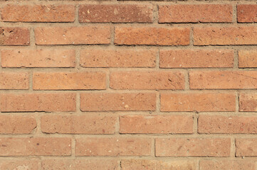 Orange color brick wall front view shot. Brick texture horizontal background.