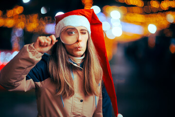 Funny Curious Christmas Woman Looking with a Magnifying Glass. Puzzled surprised girl checking and...