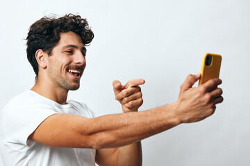 Message man selfie hipster lifestyle portrait smart t-shirt standing phone technology online white...