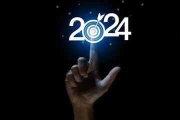 Fototapeta premium touching to Goal and target of business in new year 2024. Planning, opportunity, challenge and business strategy in new year 2024. Development to success and motivation. 