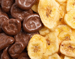 A Macro Background of Chocolate Covered Banana Chips and Original Banana Chips