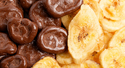 A Macro Background of Chocolate Covered Banana Chips and Original Banana Chips