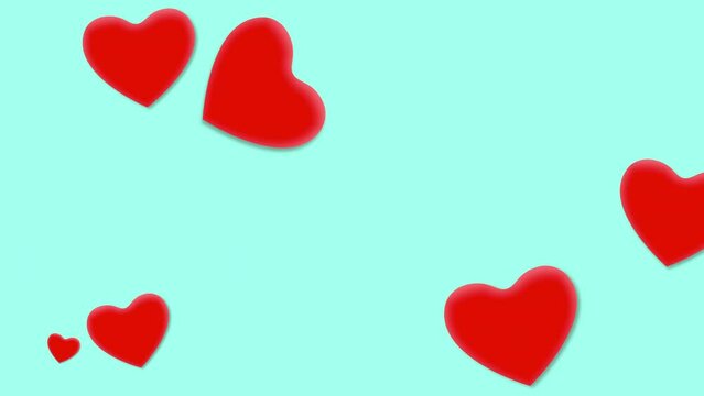 Floating red hearts made of paper or cardboard are suspended in mid-air on blue background. The hearts are cut out in the shape of hearts and appear weightless, creating a dreamy and whimsical image
