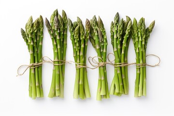 Bunches of fresh asparagus tied with natural thread on a white background,isolated,top view,close up,space for text.Generative AI - Powered by Adobe