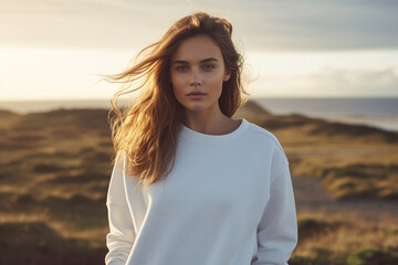 A woman in a white sweater outdoors. Sweater mockup