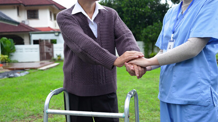 Nurse or caregiver hand on walking frame for support, help or trust moving leg in rehabilitation. Physiotherapy healthcare, Medical caregiver consulting disabled elderly patient at home