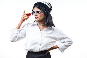 a chill look of a girl wearing white dress and black googles holding vine glass in one hand and cigar in another hand