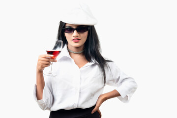 a chill look of a girl wearing white dress and black googles holding vine glass in one hand and cigar in another hand