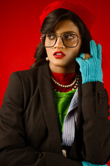 portrait of a woman wearing glasses in winter wearing coat and gloves 