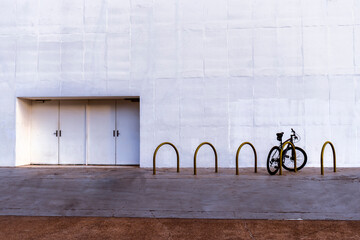 bicycle parked in the bike rack next to the emergency exit of a theater, with a large copy space area in Brazil